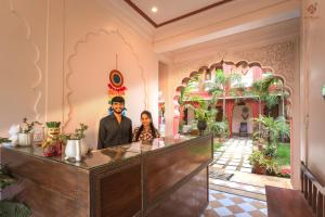a man and a woman standing at a counter in a room at Eartham Stays, Pushkar in Pushkar
