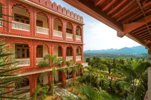 a red building with plants on the side at Eartham Stays, Pushkar in Pushkar