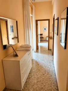 a room with a white dresser and a hallway at B&B I Pioppi Argentati in Giulianova