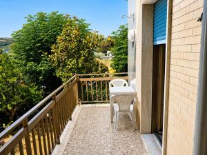 a balcony with two chairs and a table at B&B I Pioppi Argentati in Giulianova