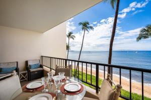 a dining room with a view of the beach at SUGAR BEACH RESORT, #421 in Kihei