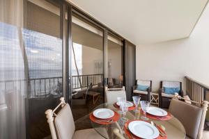 a dining room with a table and chairs and a balcony at SUGAR BEACH RESORT, #421 in Kihei +14 photos