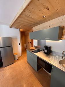 a kitchen with a sink and a counter top at Le Plainpalais - 4pers - Balcon vue Montagnes in Les Déserts +16 photos