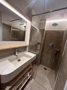 a bathroom with a sink and a shower at Le Plainpalais - 4pers - Balcon vue Montagnes in Les Déserts