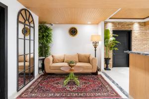 a living room with a couch and a table at SkyHouse by Ace Luxe in Islamabad