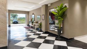 a hallway with a black and white checkered floor at SkyHouse by Ace Luxe in Islamabad