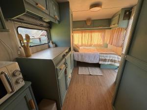 an interior view of an rv with a small bedroom at Caravana Lobo Camp in Boca de Huérgano +2 photos