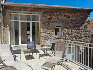 a group of chairs sitting on a balcony at La belle étoile in Saugues