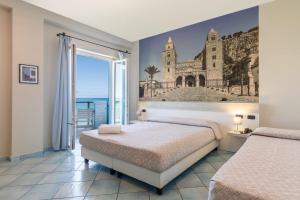 ein Schlafzimmer mit zwei Betten und Meerblick in der Unterkunft Hotel Tourist in Cefalú + 106 Fotos