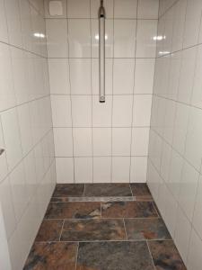 a bathroom with a shower with a tiled floor at La belle étoile in Saugues