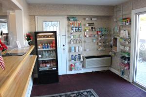 a kitchen with a refrigerator and a counter with drinks at Highlander Motor Inn Atlantic City in Galloway