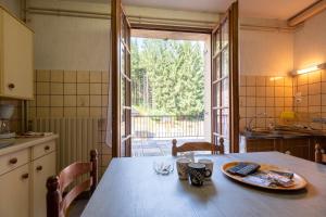 a kitchen with a table with a plate on it at La Petite Caille - Appartement 10 in Plombières-les-Bains