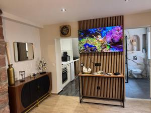 a living room with a large aquarium on the wall at Large studio in Obernai in Obernai