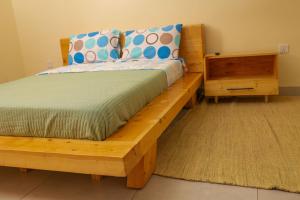 a bedroom with a wooden bed and a night stand at RP Gorilla Guest & Coffee in Taba