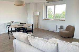 a living room with a couch and a table at appartement la pause coté mer in Santec