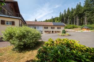 an empty parking lot in front of a building at La Petite Caille - Appartement 10 in Plombières-les-Bains