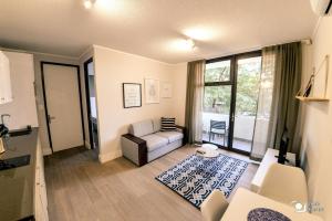 a living room with a couch and a large window at iKON Apartments in Windhoek +37 photos