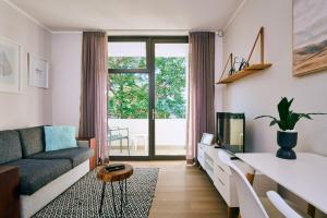 a living room with a couch and a tv at iKON Apartments in Windhoek
