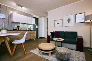 a living room with a couch and a table at iKON Apartments in Windhoek