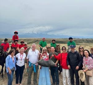a group of people posing for a picture with a group of animals at Reina-Kench in Kunduy
