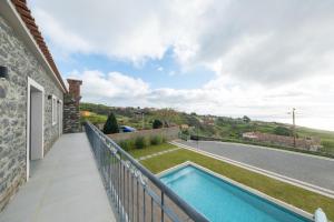 a swimming pool on the balcony of a house at Ponta do Pargo Village - By WeHostMadeira in Ponta do Pargo +26 photos