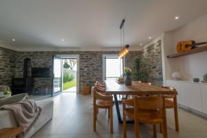a kitchen and dining room with a wooden table and chairs at Ponta do Pargo Village - By WeHostMadeira in Ponta do Pargo