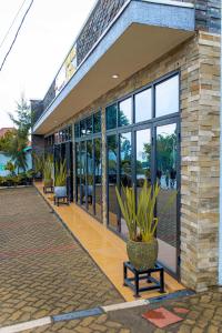 a building with large windows and potted plants at RP Gorilla Guest & Coffee in Taba