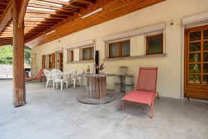 a patio with a table and chairs on a house at La Petite Caille - Appartement 4 in Plombières-les-Bains
