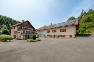 a large building with solar panels on its roof at La Petite Caille - Appartement 4 in Plombières-les-Bains