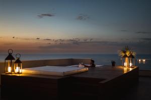 a woman sitting in a hot tub on the beach at Hotel Sporting Riccione in Riccione +108 photos