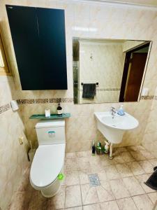 a bathroom with a toilet and a sink at Pinkliey House in Ilsan-yŏk +17 photos