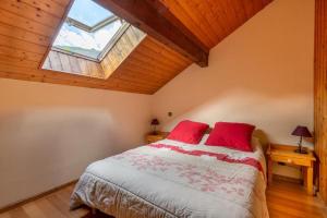 a bedroom with a bed with red pillows and a window at Les Balcons de St So Appartement B in Saint-Sorlin-dʼArves +5 photos