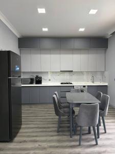 a kitchen with a table and chairs in a room at Elite Novkhany-Corat Villa in Corat