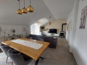 a living room with a table and a couch at Villa Brig in Ramljane