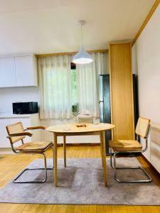 a kitchen and dining room with a table and chairs at Pinkliey House in Ilsan-yŏk