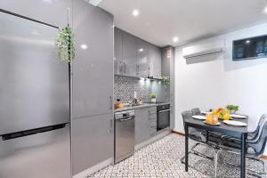 a kitchen with a black table and a counter at OPORTO APARTMENT LUXURY in Porto +23 photos