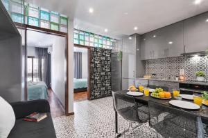 a kitchen and a living room with a table in a room at OPORTO APARTMENT LUXURY in Porto