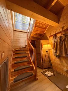 a wooden staircase in a cabin with a window at Stausee-Haus in Neumühle +14 photos