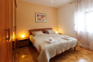 a bedroom with a bed with two towels on it at Villa Brig in Ramljane +89 photos