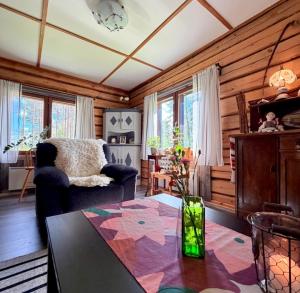 a living room with a couch and a table at Mattilan talo b&b in Impiö