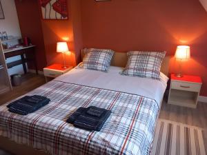a bedroom with a bed with two black bags on it at Bénodet Chambre D'hôtes Les Sauges in Bénodet +20 photos