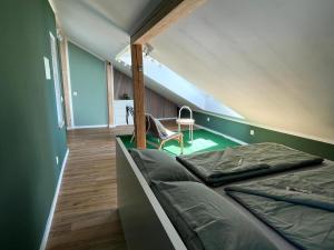 a room with a bed and a chair in it at FerienNest Kelheim in Kelheim