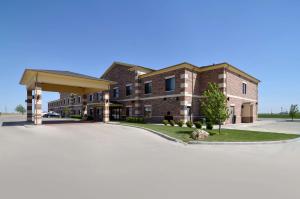 a large brick building with a parking lot at Quality Inn Perryton in Perryton