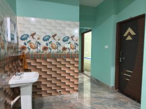 a bathroom with a sink and a mirror at Das & Das Hotel in Bhubaneshwar