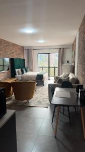 a living room with a couch and a bed at CS Nest Modern Studio Athlone in Pietermaritzburg