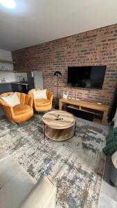 a living room with two chairs and a coffee table at CS Nest Modern Studio Athlone in Pietermaritzburg