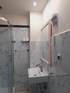 a bathroom with a sink and a shower at Hotel i Apartamenty Rosa in Przemyśl