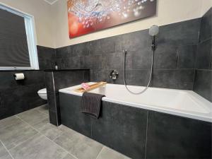 a bathroom with a bath tub and a shower at Natur pur Eifel in Gerolstein