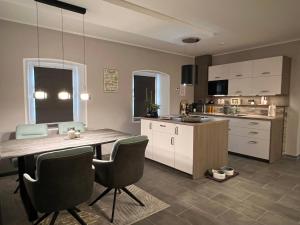 a kitchen with a table and chairs in a kitchen at Natur pur Eifel in Gerolstein +22 photos