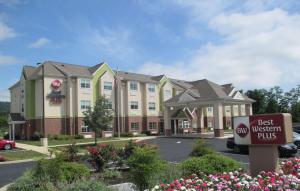 a hotel with a best western plus sign in a parking lot at Best Western Plus Harrisburg Mechanicsburg in Enola